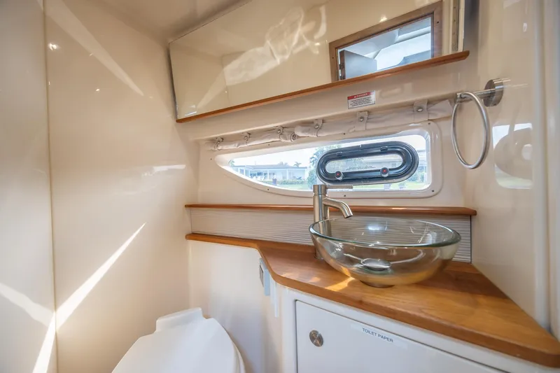 Slide: The Image of Luxurious bathroom in 2019 Sea Ray Sundancer 350 Coupe yacht with glass sink and wooden accents. - 46