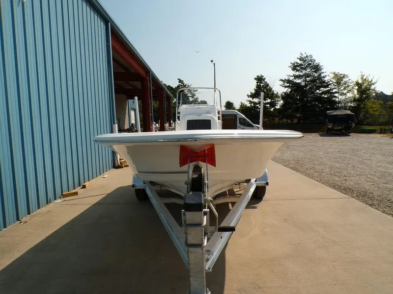 Slide: The Image of 2025 Tidewater 1910 Bay Max boat on trailer, parked outside a blue building. - 11