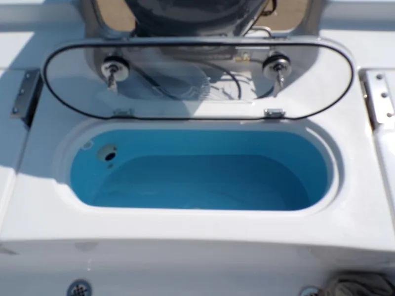 Slide: The Image of Livewell on 2025 Tidewater 1910 Bay Max boat, open lid, blue interior. - 9