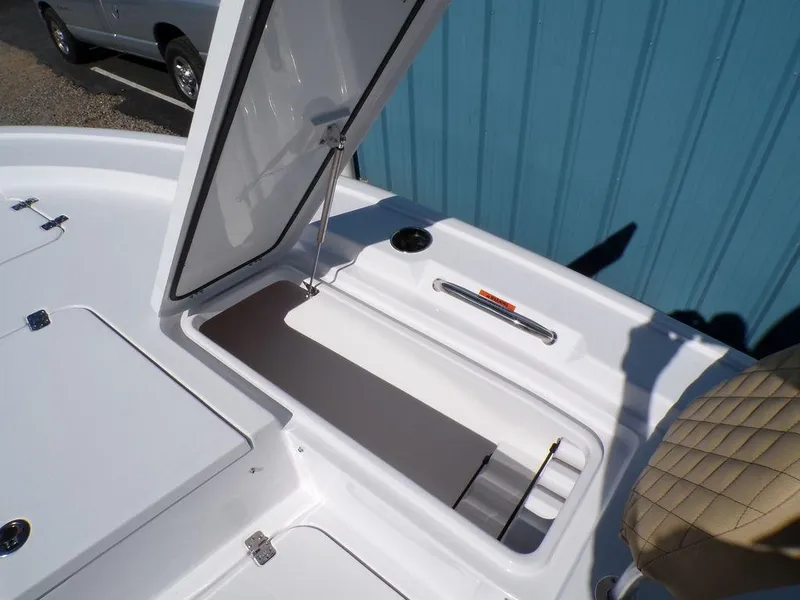 Slide: The Image of 2025 Sportsman Masters 247 boat storage compartment with open hatch, showcasing interior space. - 18