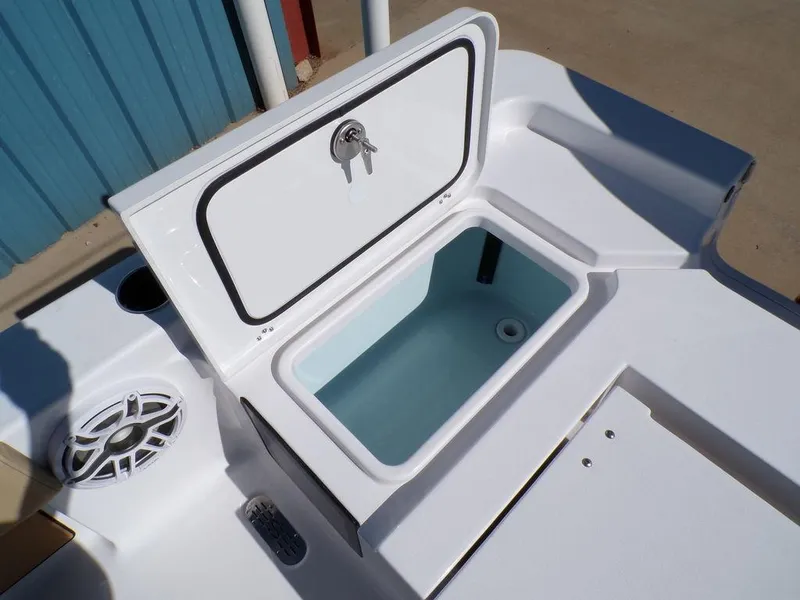 Slide: The Image of 2025 Sportsman Masters 247 boat storage compartment with open lid and speaker. - 19
