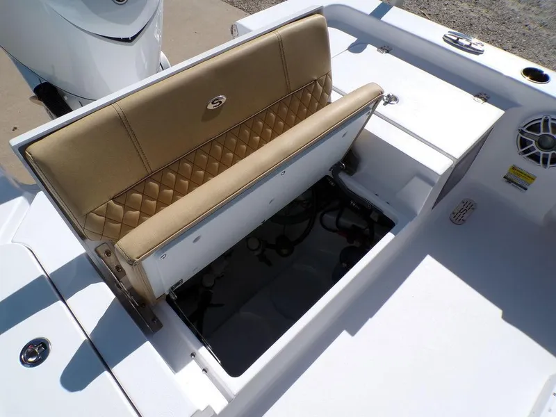 Slide: The Image of 2025 Sportsman Masters 247 boat with open storage compartment and tan cushioned seat. - 21