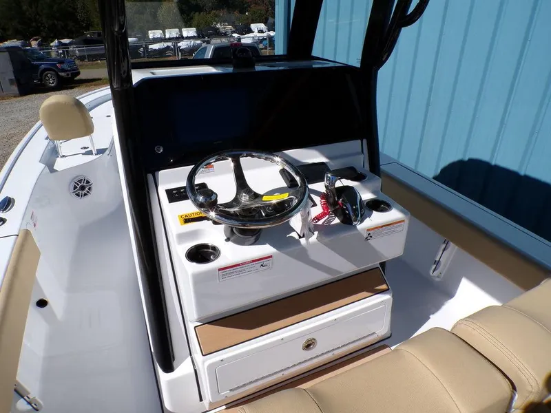 Slide: The Image of 2025 Sportsman Masters 247 boat console with steering wheel and controls. - 23