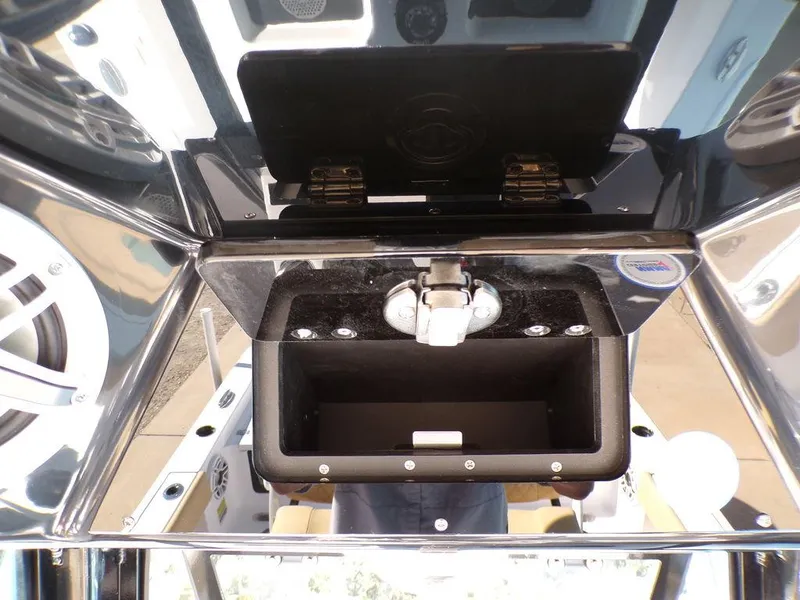 Slide: The Image of 2025 Sportsman Masters 247 boat storage compartment with latch and speakers. - 25