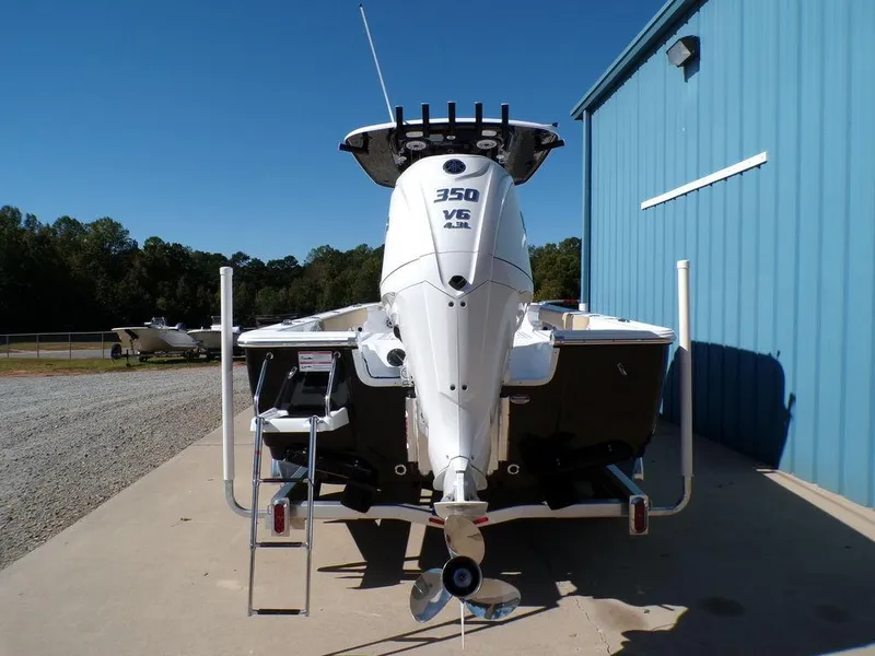 Slide: The Image of 2025 Sportsman Masters 247 boat with 350 V6 engine, parked near a blue building. - 3