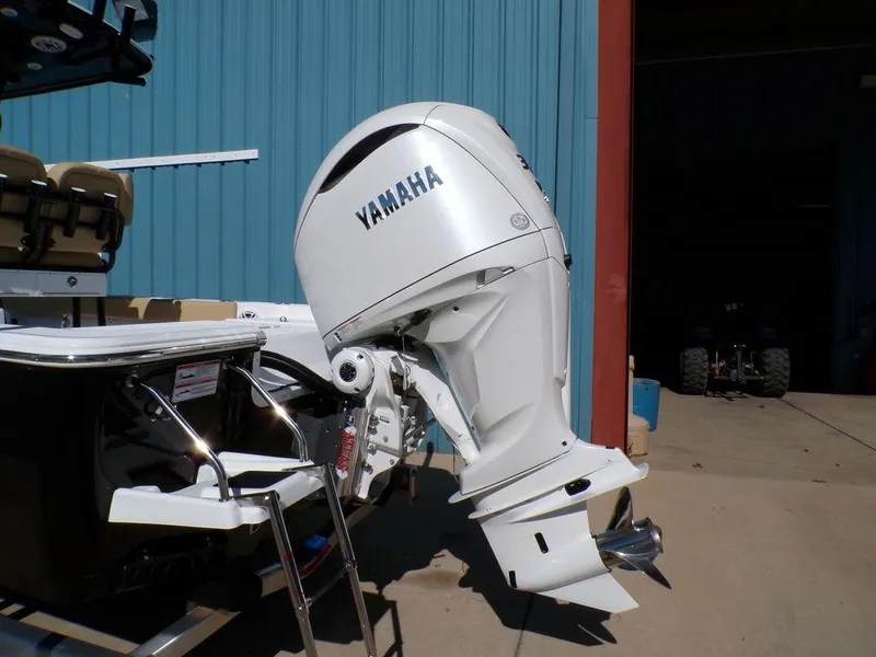 Slide: The Image of 2025 Sportsman Masters 247 boat with Yamaha outboard motor, docked near a blue building. - 5