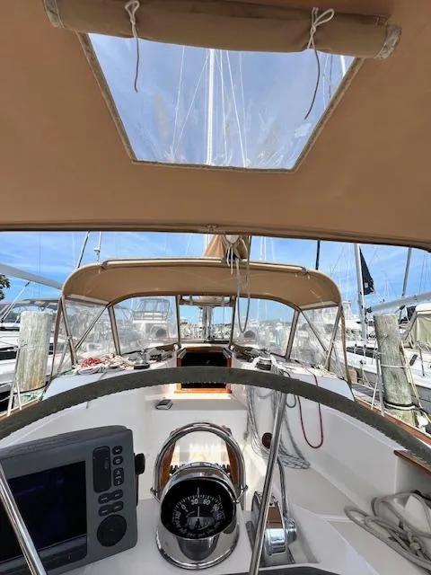 Slide: The Image of 1998 Tartan 4100 sailboat cockpit with navigation equipment and canopy. - 10