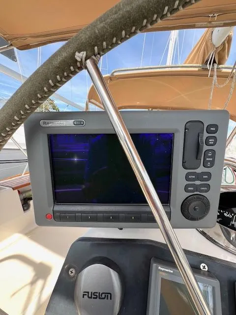 Slide: The Image of 1998 Tartan 4100 sailboat cockpit with navigation equipment and steering wheel. - 11