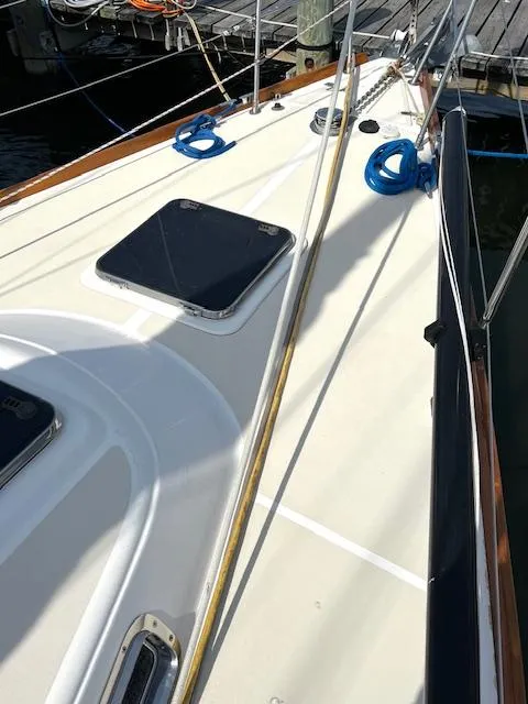 Slide: The Image of 1998 Tartan 4100 sailboat deck with hatches and ropes at dock. - 28