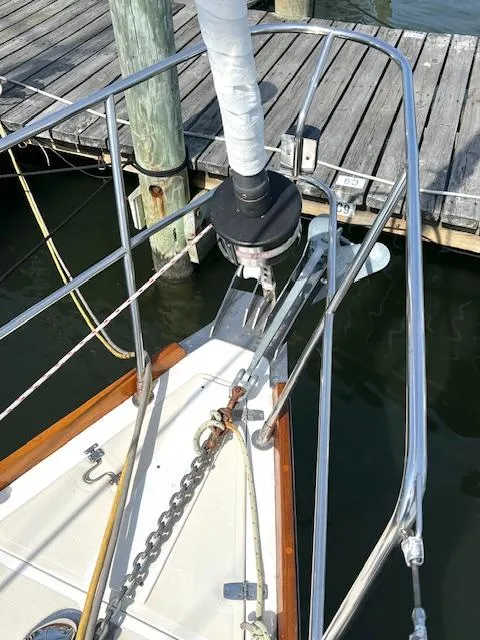 Slide: The Image of Bow of 1998 Tartan 4100 sailboat docked, featuring anchor and railing. - 29