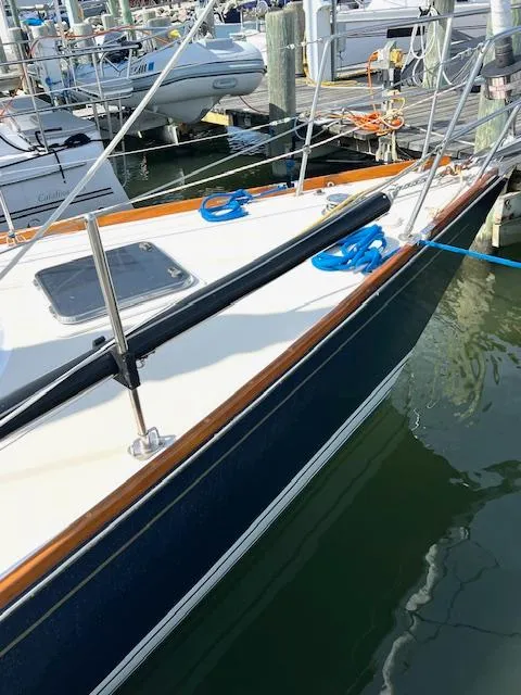 Slide: The Image of 1998 Tartan 4100 sailboat docked at marina, featuring sleek design and polished wood accents. - 3