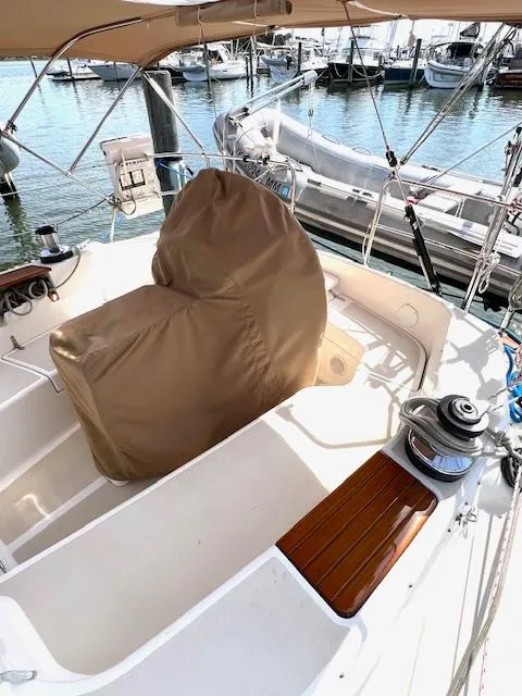 Slide: The Image of 1998 Tartan 4100 sailboat cockpit with covered helm, docked in marina. - 33