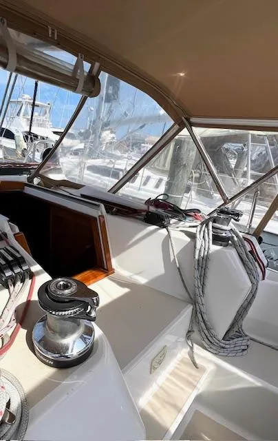 Slide: The Image of 1998 Tartan 4100 sailboat cockpit with winch and ropes, docked at marina. - 4