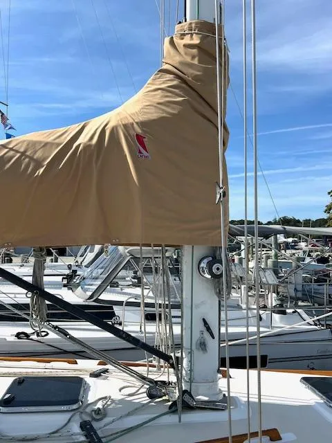 Slide: The Image of 1998 Tartan 4100 sailboat mast with beige cover in marina. - 40