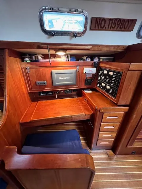 Slide: The Image of 1998 Tartan 4100 yacht interior with navigation station and control panel. - 41