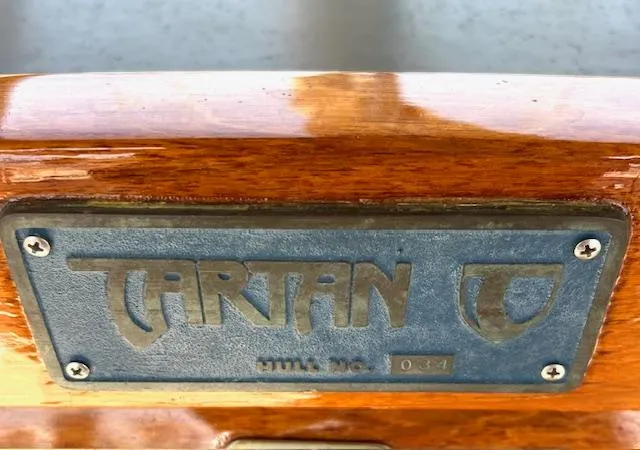 Slide: The Image of Tartan 4100 sailboat nameplate, 1998 model, hull number 037, on polished wood surface. - 42