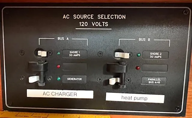 Slide: The Image of AC source selection panel for Tartan 4100, 1998, with switches for charger and heat pump. - 47