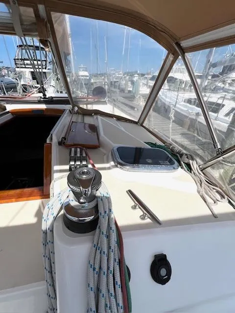 Slide: The Image of 1998 Tartan 4100 sailboat cockpit with winch and ropes in a marina setting. - 5