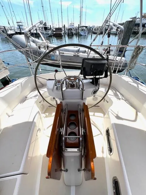 Slide: The Image of 1998 Tartan 4100 sailboat cockpit with steering wheel and navigation equipment. - 7