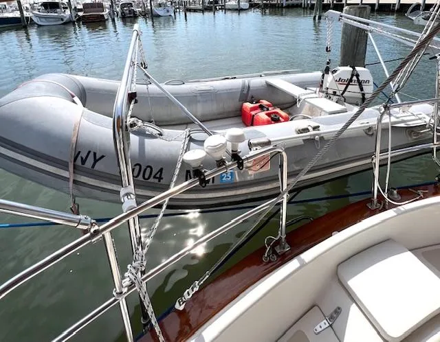 Slide: The Image of Inflatable dinghy docked beside 1998 Tartan 4100 sailboat in marina. - 8