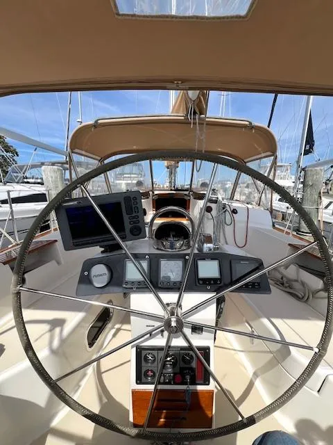 Slide: The Image of 1998 Tartan 4100 sailboat cockpit with steering wheel and navigation instruments. - 9