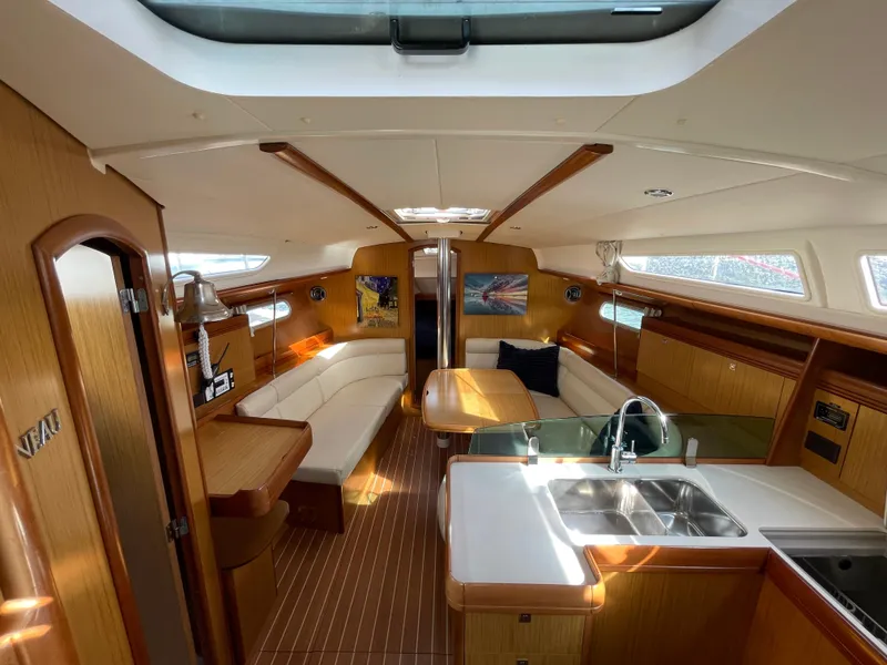 Slide: The Image of Interior of 2008 Jeanneau 39i sailboat with modern kitchen and cozy seating area. - 14