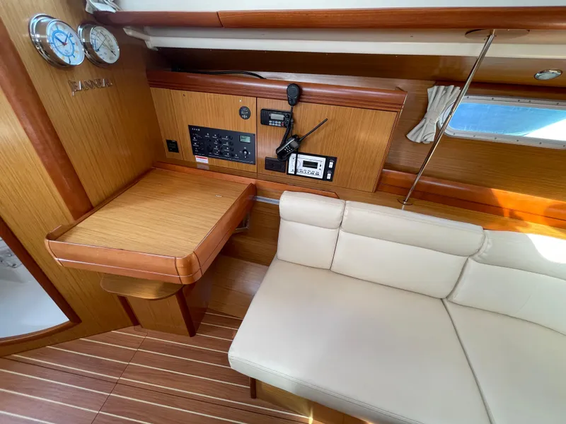 Slide: The Image of Interior of 2008 Jeanneau 39i sailboat with navigation station and seating area. - 15
