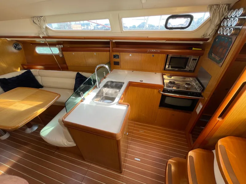 Slide: The Image of Interior of 2008 Jeanneau 39i sailboat with kitchen and dining area. - 16