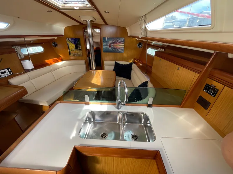 Slide: The Image of Interior of 2008 Jeanneau 39i sailboat with modern kitchen and cozy seating area. - 17