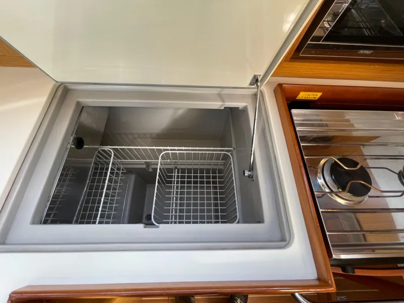 Slide: The Image of Jeanneau 39i 2008 yacht kitchen with open fridge and stove. - 18