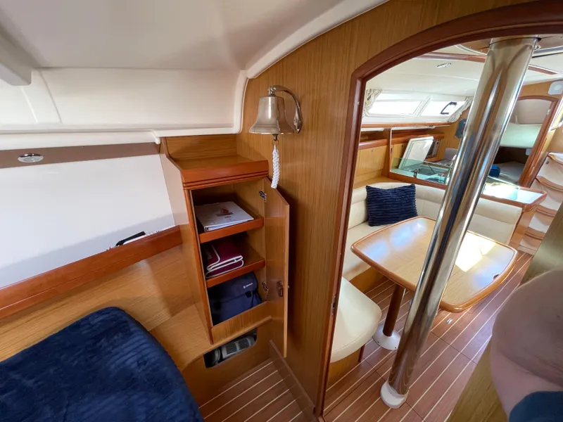 Slide: The Image of Interior of 2008 Jeanneau 39i sailboat with wood finish and cozy seating area. - 23