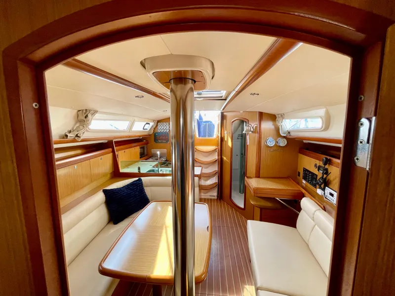Slide: The Image of Interior of 2008 Jeanneau 39i sailboat with wood finish and cozy seating area. - 24