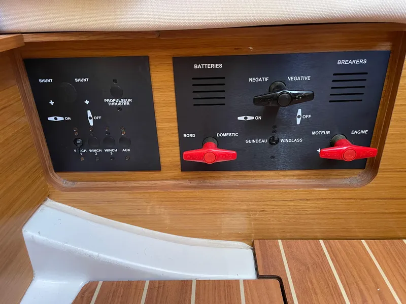 Slide: The Image of Control panel of a 2008 Jeanneau 39i sailboat, featuring battery and breaker switches. - 34