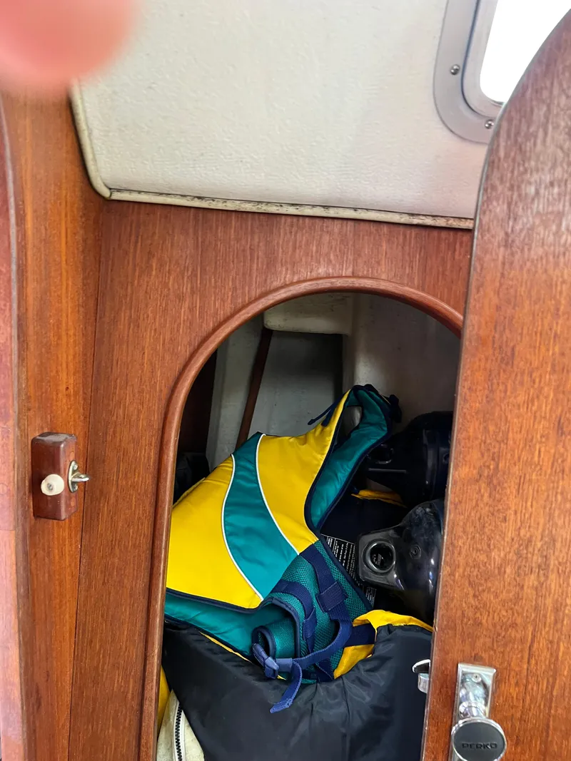 Slide: The Image of Interior cabin of 1989 J Boats 35 with colorful gear stored inside. - 14