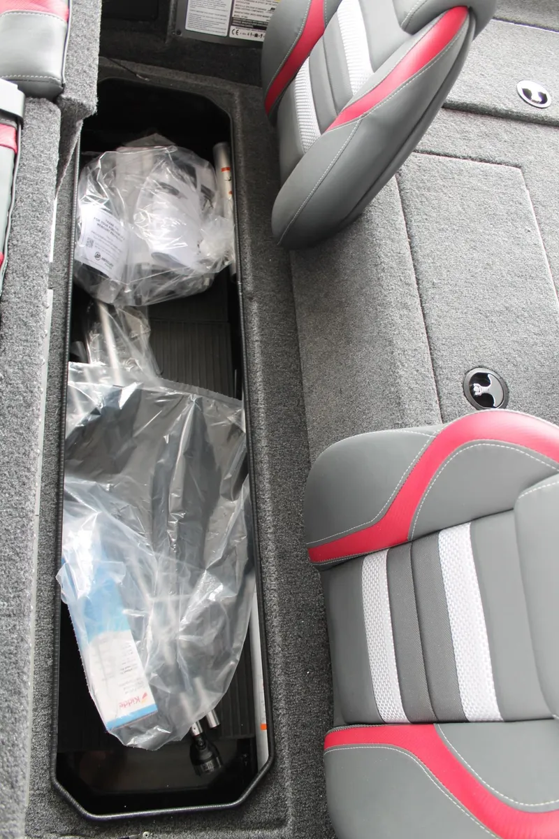 Slide: The Image of 2024 Ranger RT188C boat interior storage compartment with seats and packaged items. - 11