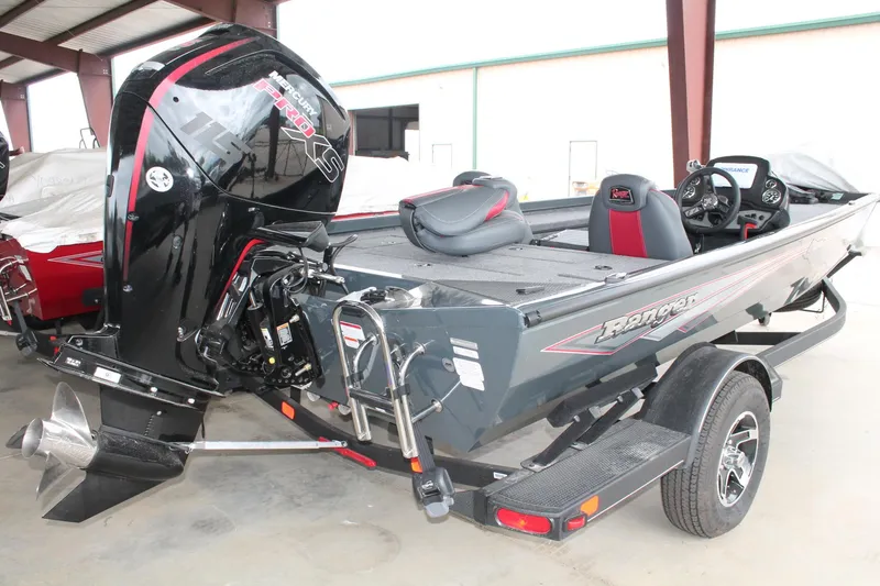 Slide: The Image of 2024 Ranger RT188C fishing boat with powerful outboard motor in a covered storage area. - 14