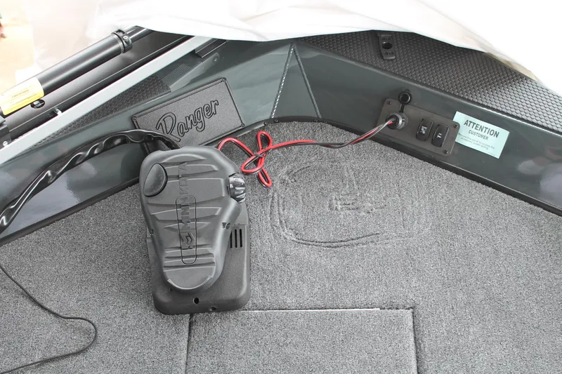 Slide: The Image of 2024 Ranger RT188C boat interior with trolling motor pedal and wiring. - 17