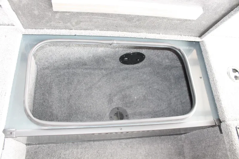 Slide: The Image of 2024 Ranger RT188C boat storage compartment with carpeted interior. - 8