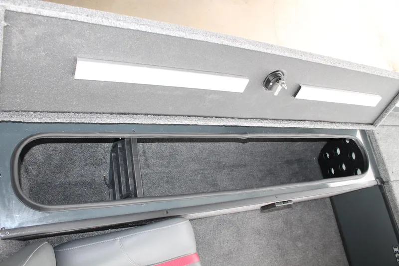 Slide: The Image of 2024 Ranger RT188C boat storage compartment with key lock and carpeted interior. - 9