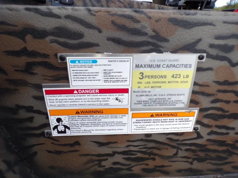 Slide: The Image of Safety and capacity labels on 2025 Xpress XTS16 boat, camouflage pattern background. - 2