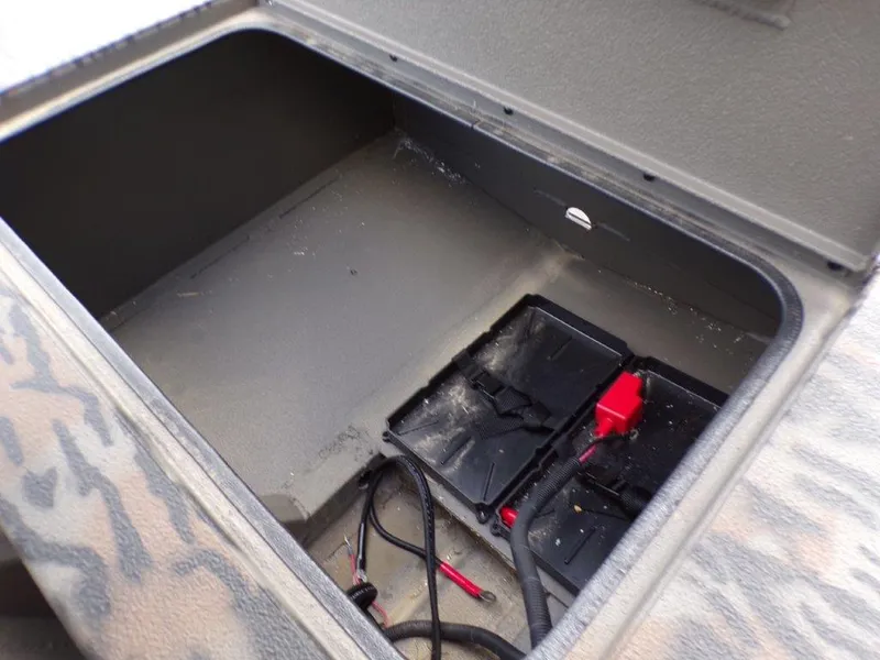 Slide: The Image of Open storage compartment in 2025 Xpress XTS16 boat with battery and cables. - 3
