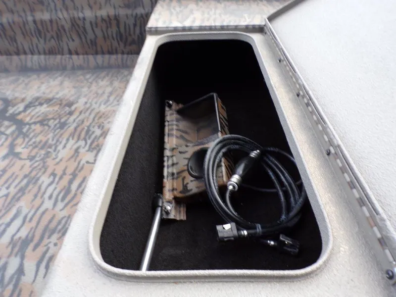 Slide: The Image of Open storage compartment in 2025 Xpress XTS16 boat with cables and accessories. - 5