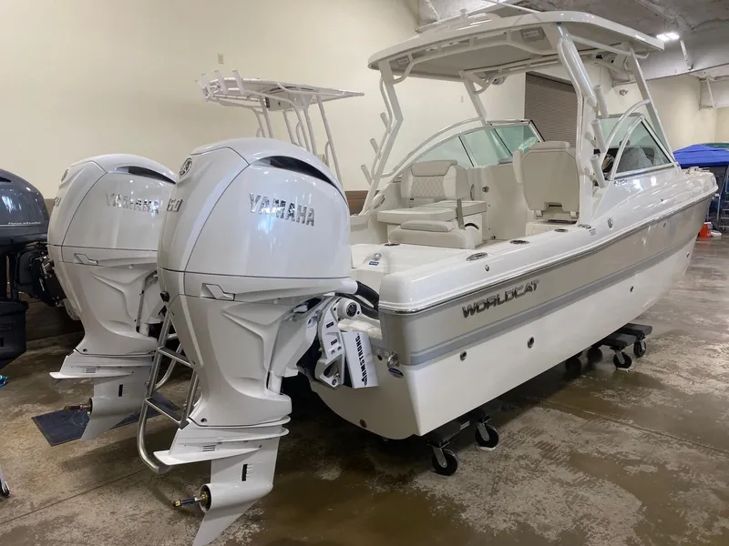 Slide: The Image of 2025 World Cat 230DC boat with dual Yamaha engines in showroom. - 2