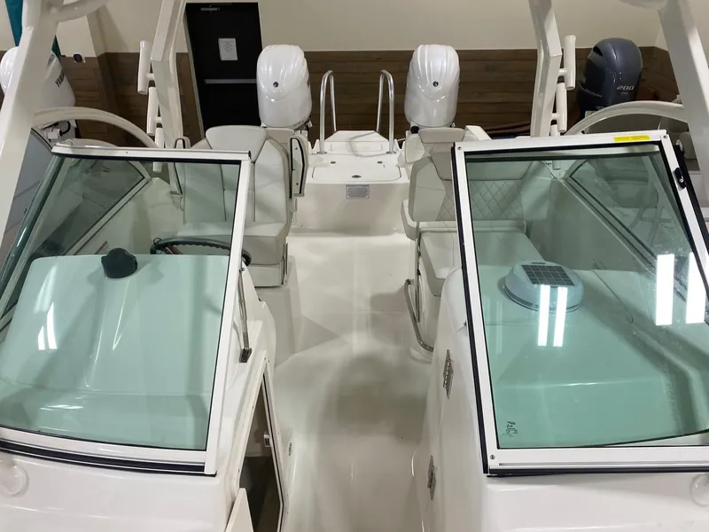 Slide: The Image of 2025 World Cat 230DC boat interior with dual consoles and seating. - 4