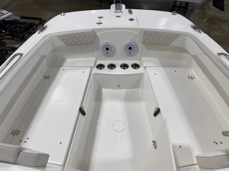 Slide: The Image of 2025 World Cat 230DC boat interior with seating and storage compartments. - 6