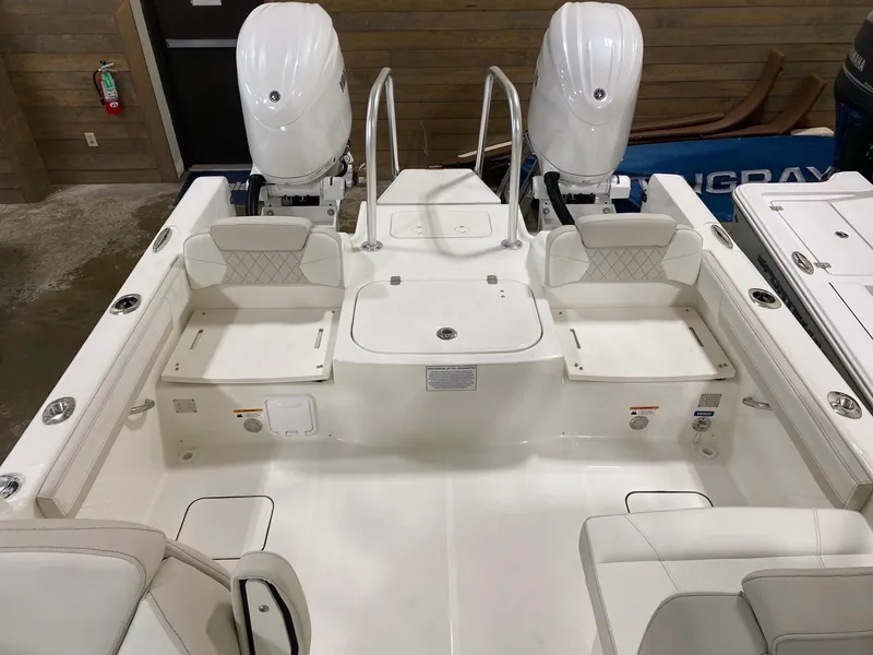 Slide: The Image of 2025 World Cat 230DC boat interior with dual engines and seating. - 8