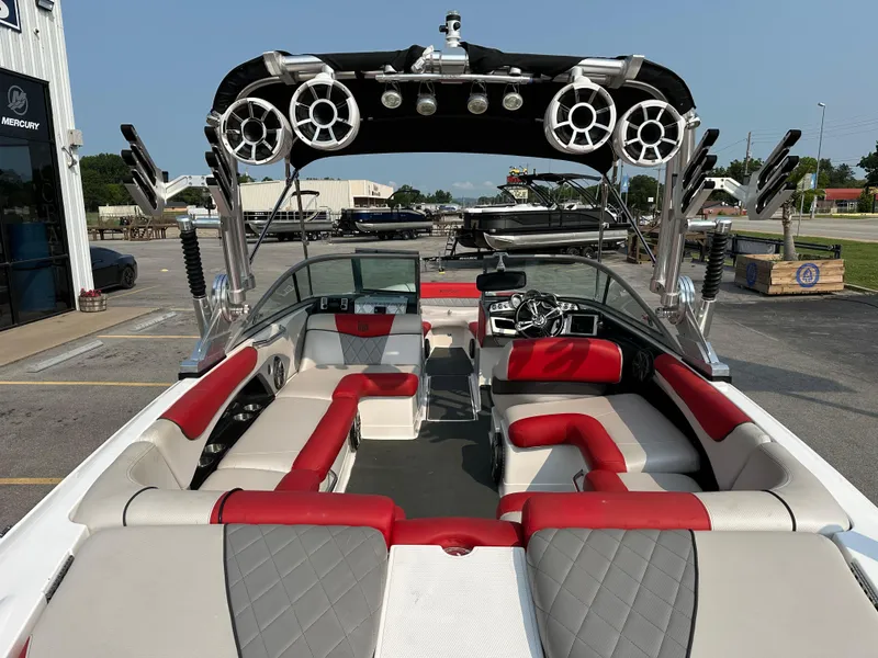 Slide: The Image of 2012 MasterCraft X45 boat interior with red and gray seating, speakers, and steering wheel. - 16