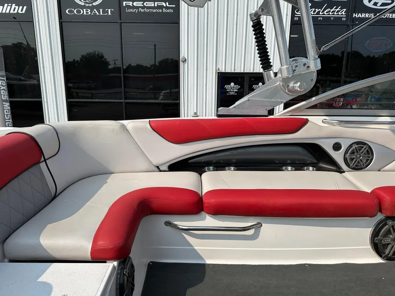 Slide: The Image of 2012 MasterCraft X45 boat interior with red and white seating, near luxury boat dealership. - 19