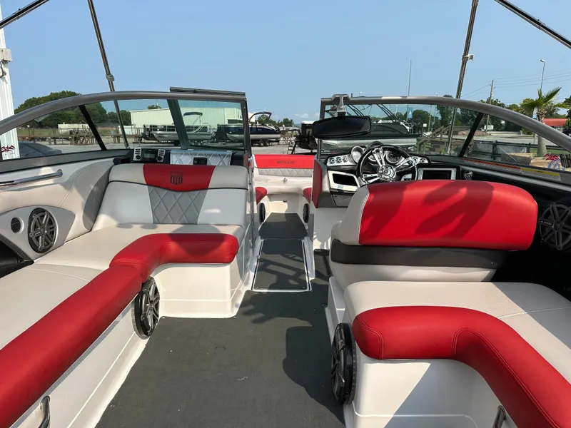 Slide: The Image of 2012 MasterCraft X45 boat interior with red and white seating, sleek dashboard, and modern design. - 20