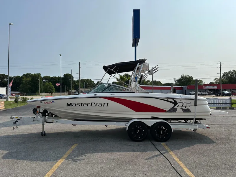 Slide: The Image of 2012 MasterCraft X45 boat on trailer in parking lot, side view. - 5